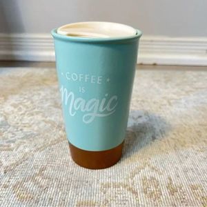 Starbucks coffee tumbler in turquoise and gold with coffee is magic
